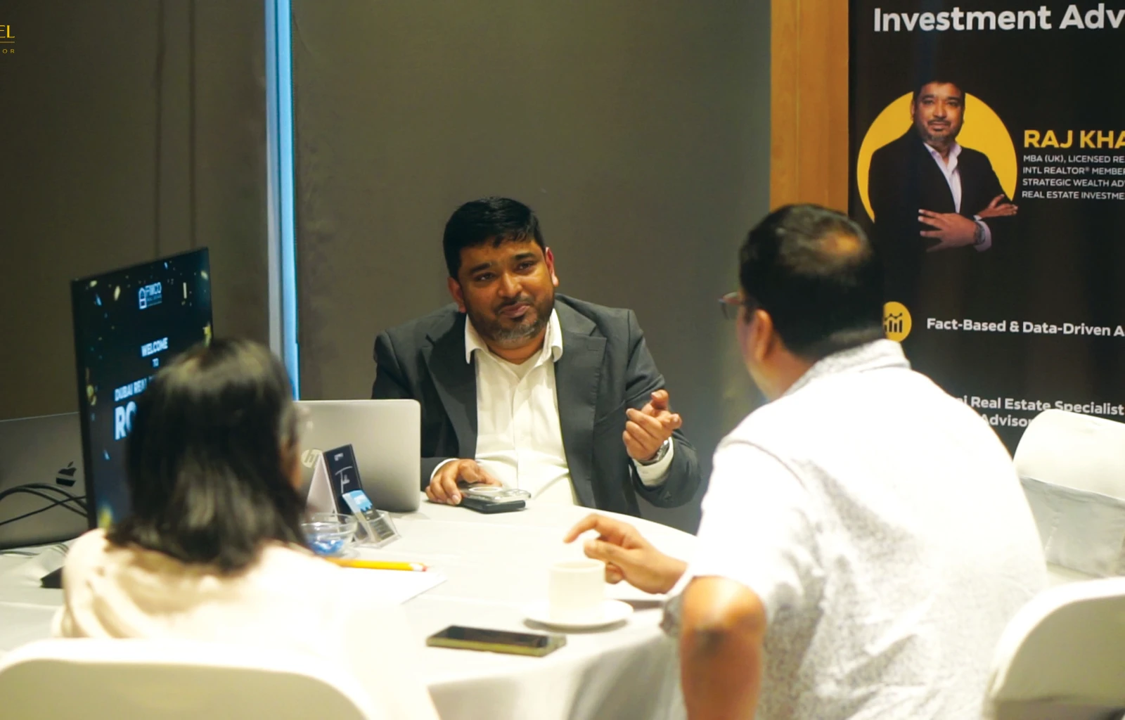 Raj Khaleel in a client consultation, reviewing a Dubai real estate decision