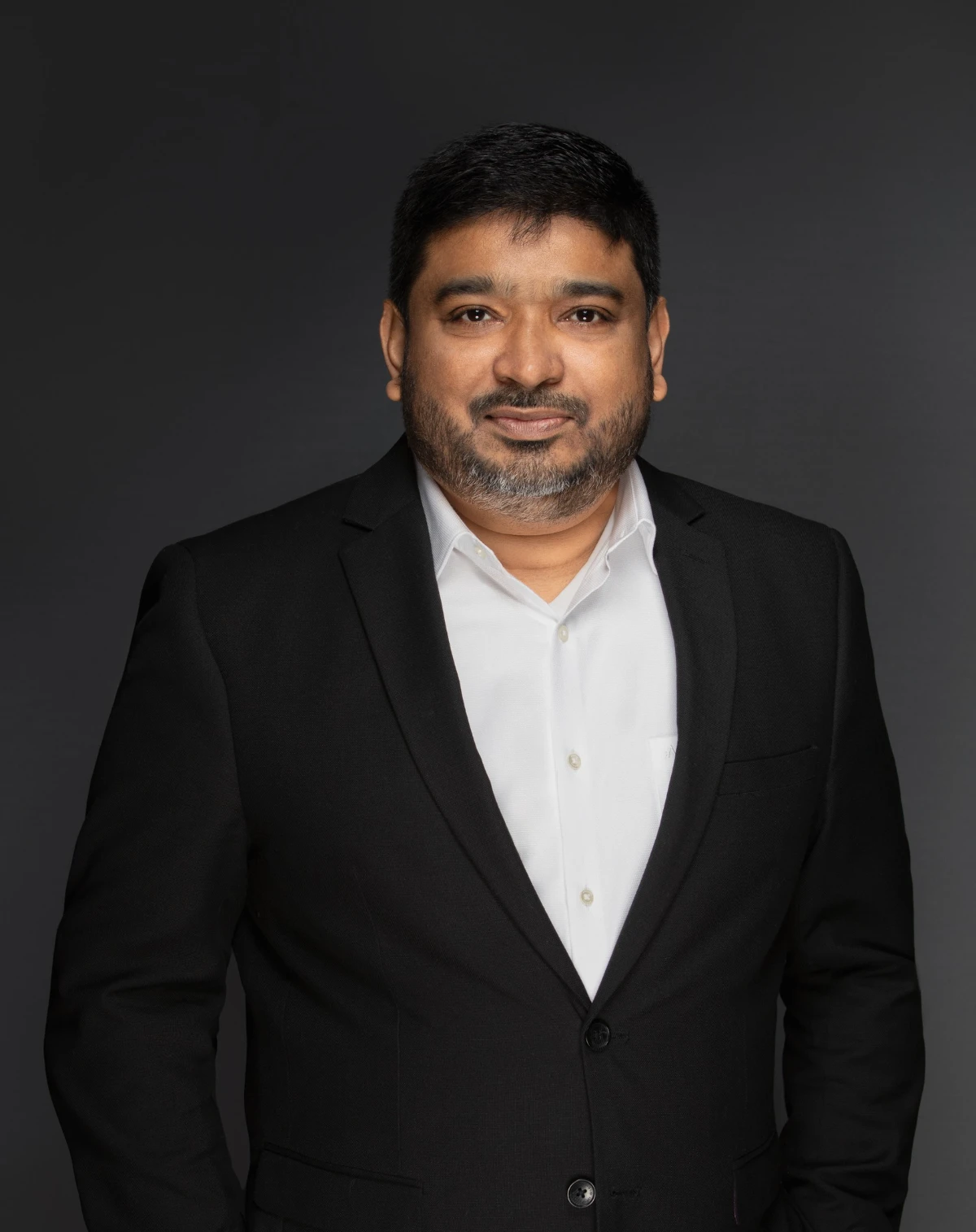Raj Khaleel, Dubai Real Estate Strategist & Wealth Advisor — black suit studio portrait